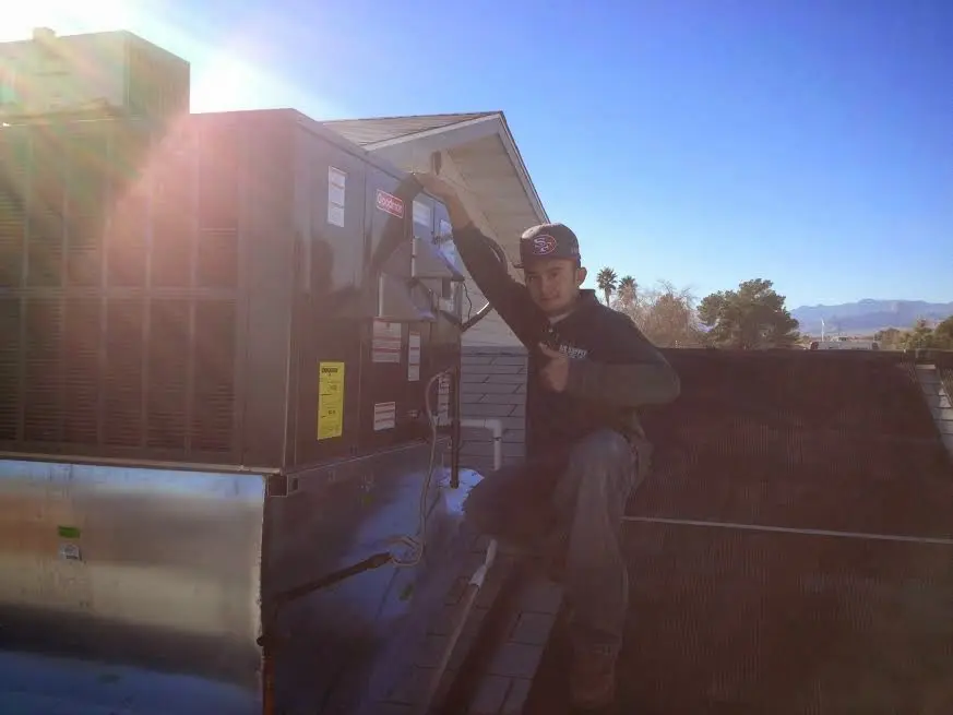 HVAC technician performing Air Duct Repair on a rooftop unit in South Monrovia Island